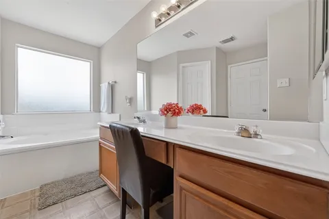 a bathroom with a bathtub sink and a mirror