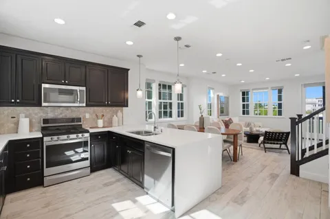 a large kitchen with stainless steel appliances lots of counter top space