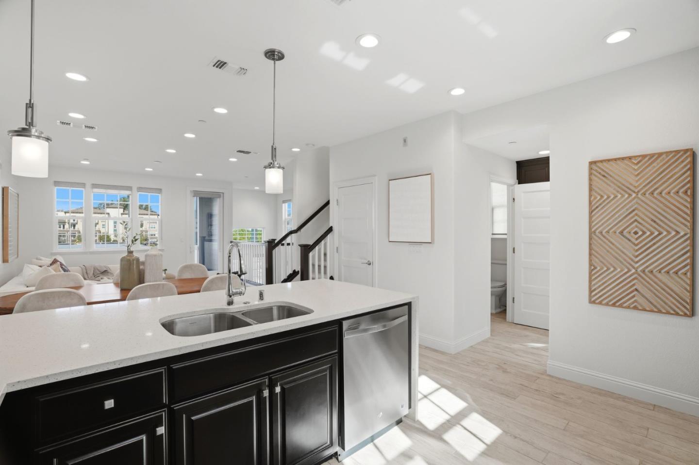3806 Pyramid Way Mountain View, CA 94043 - Photo 13 of 44 a kitchen with stainless steel appliances kitchen island granite countertop a sink and white cabinets with wooden floor
