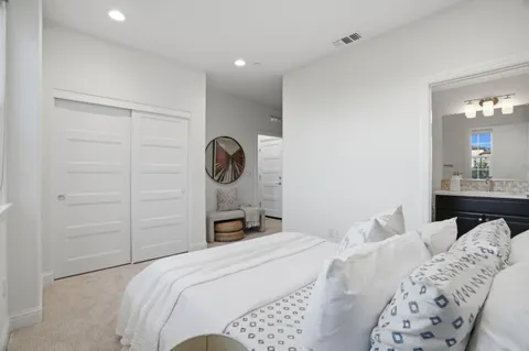 a bedroom with a bed and lamp