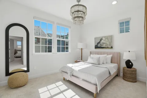a bedroom with a bed and a chandelier