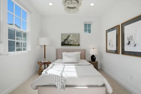 a bed sitting in a bedroom next to a window