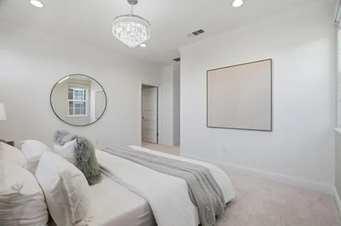 a bedroom with a bed and a mirror