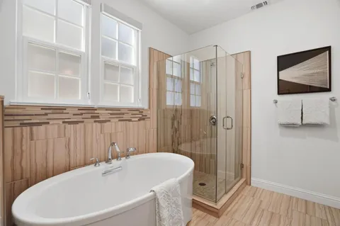 a bathroom with a bathtub and a shower