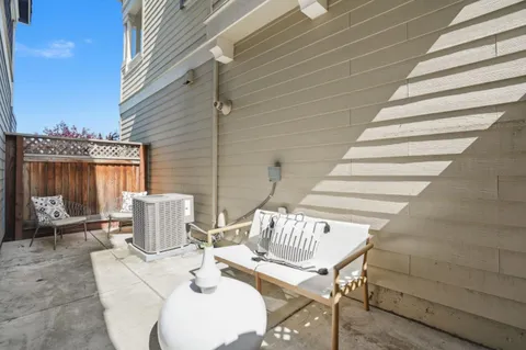 a view of a patio with table and chairs and wooden floor