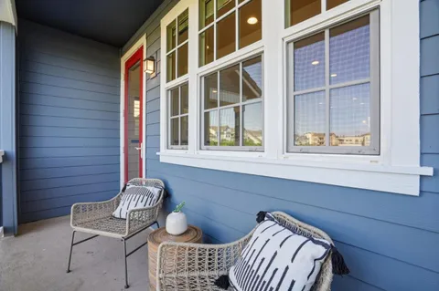 a view of front door with chair and bench