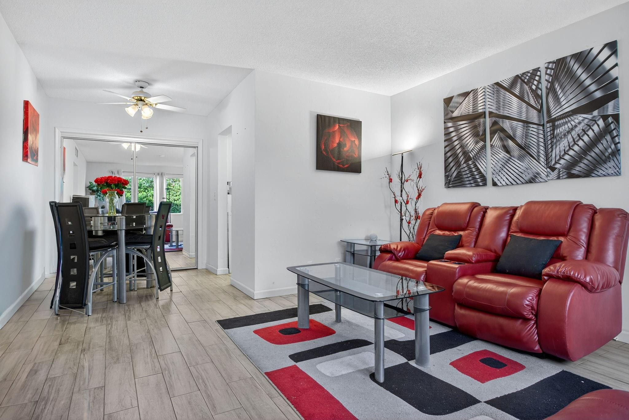 418 South Cypress Road, Unit 110 Pompano Beach, FL 33060 - Photo 2 of 28 a living room with furniture and wooden floor