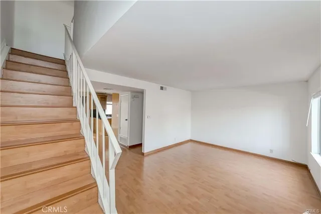 a view of an entryway with wooden floor
