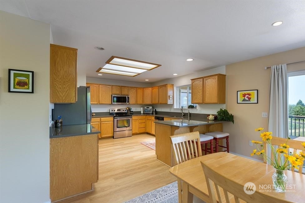 41 Onyx Lane Sequim, WA 98382 - Photo 16 of 40 a kitchen with stainless steel appliances kitchen island granite countertop a sink and cabinets