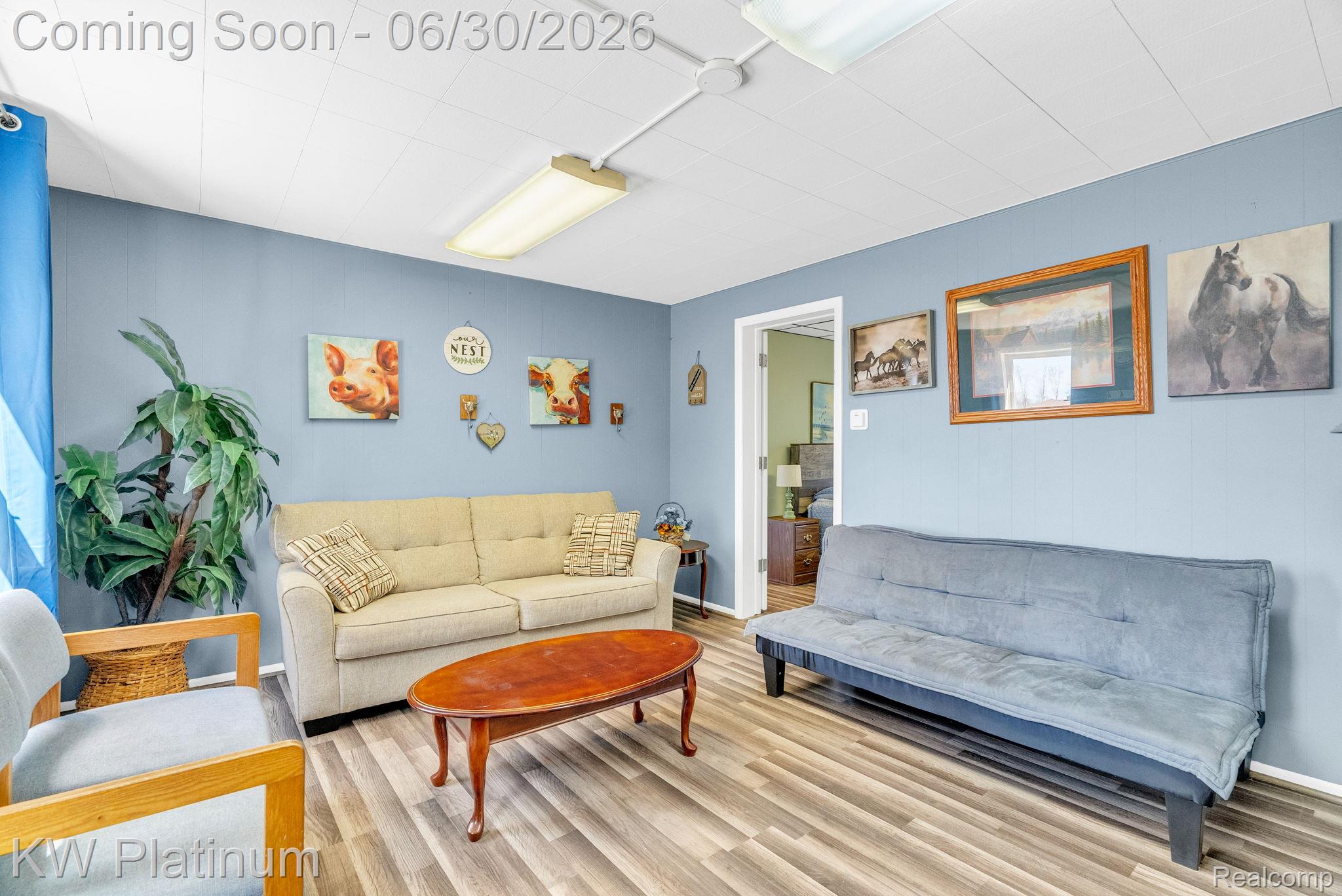 2235 South Lake Shore Road Harbor Beach, MI 48441 - Photo 68 of 99 Spacious room featuring wood-finish flooring, a drop ceiling with fluorescent lighting, and light blue wall paint