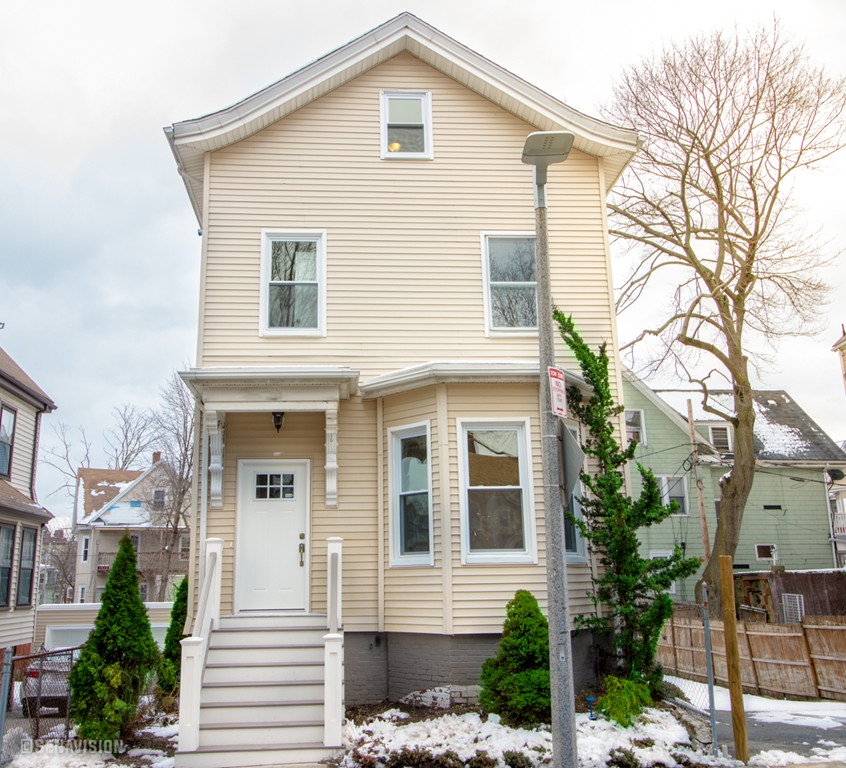 40 Humphreys Street Boston, MA 02125 - Photo 1 of 13 a front view of a house with a yard