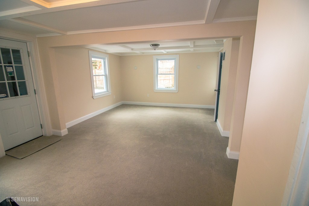 40 Humphreys Street Boston, MA 02125 - Photo 11 of 13 a view of a big room with windows and chandelier