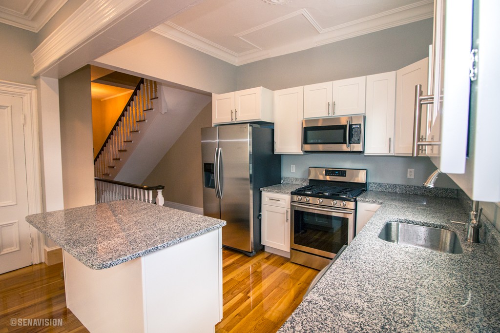 40 Humphreys Street Boston, MA 02125 - Photo 2 of 13 a kitchen with stainless steel appliances granite countertop a stove a sink and a refrigerator