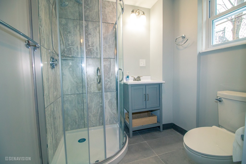 40 Humphreys Street Boston, MA 02125 - Photo 3 of 13 a bathroom with a toilet a sink and shower