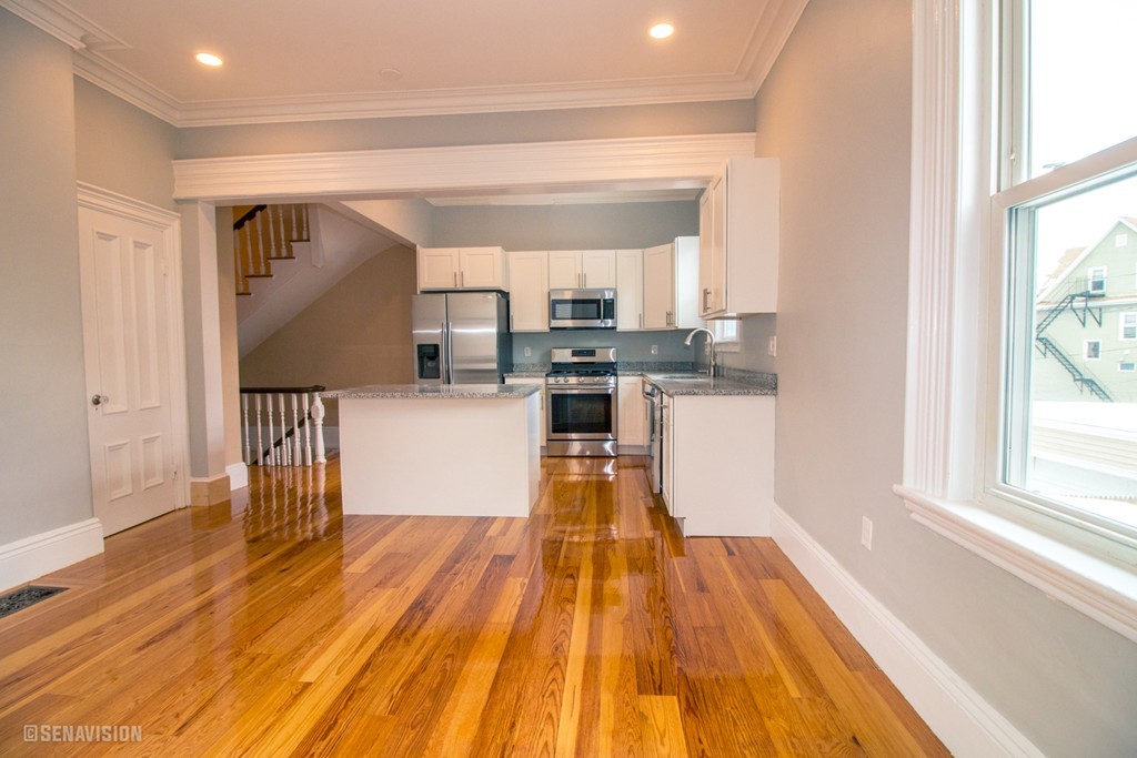 40 Humphreys Street Boston, MA 02125 - Photo 6 of 13 a kitchen with wooden floors and a window