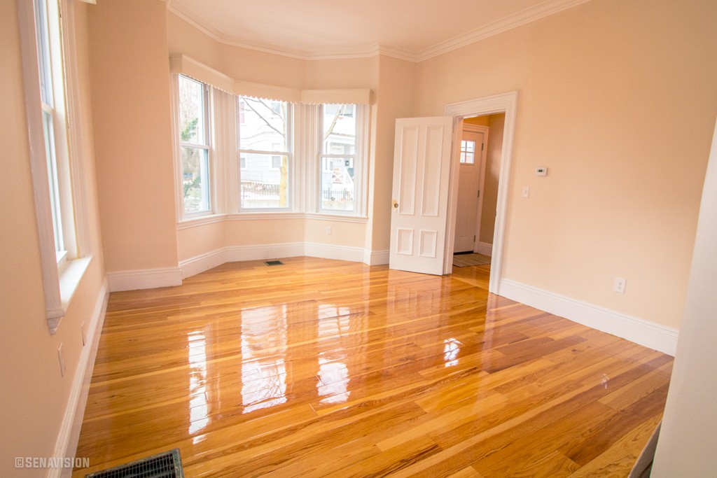40 Humphreys Street Boston, MA 02125 - Photo 8 of 13 a view of empty room with wooden floor and fan