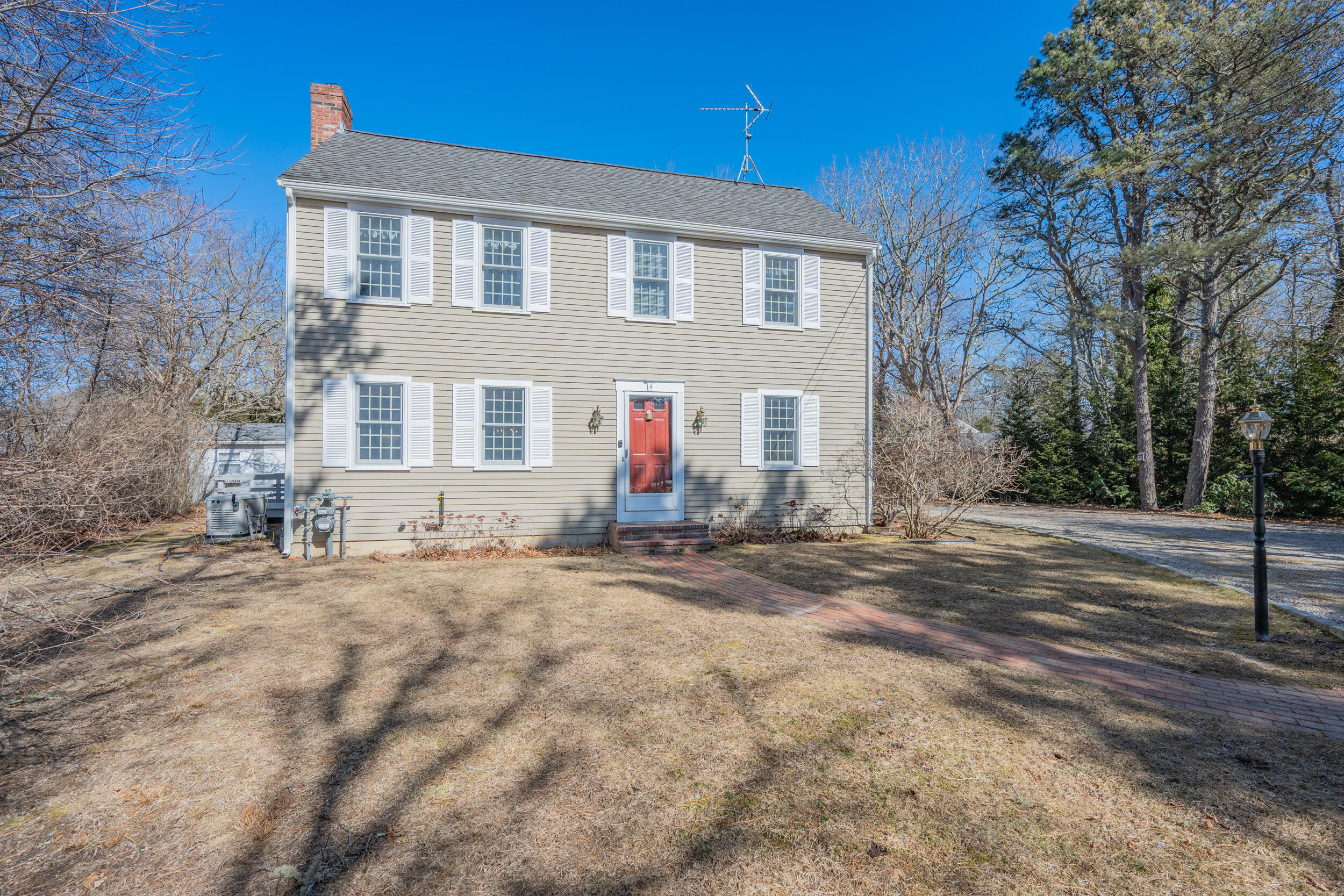 4 Ralyn Road Cotuit, MA 02635 - Photo 2 of 53 a front view of a house with a yard