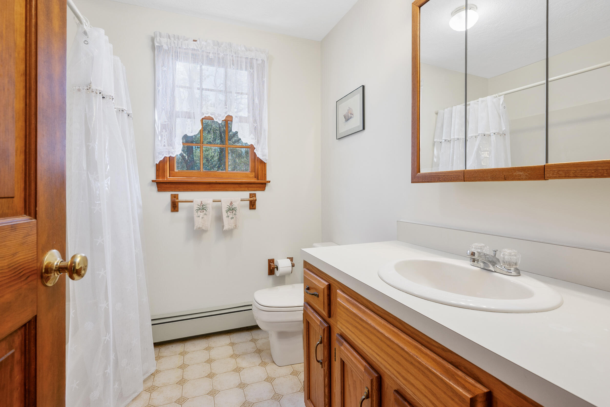 4 Ralyn Road Cotuit, MA 02635 - Photo 23 of 53 a bathroom with a sink toilet and shower