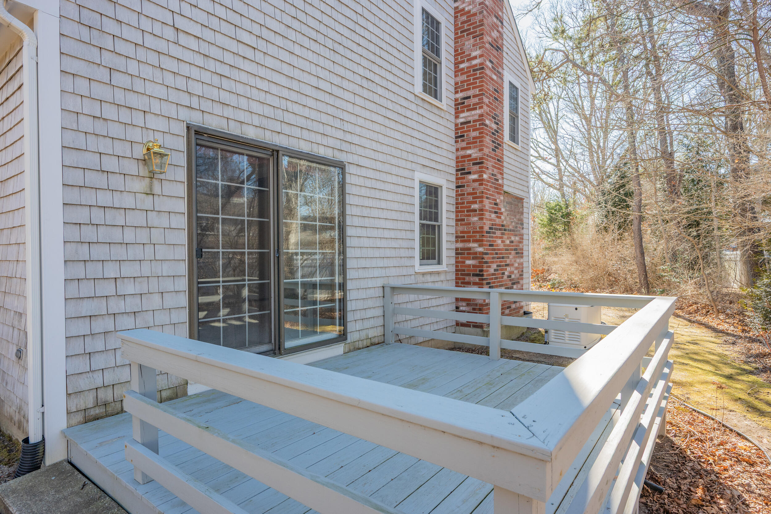 4 Ralyn Road Cotuit, MA 02635 - Photo 26 of 53 a view of a patio with a table and chairs