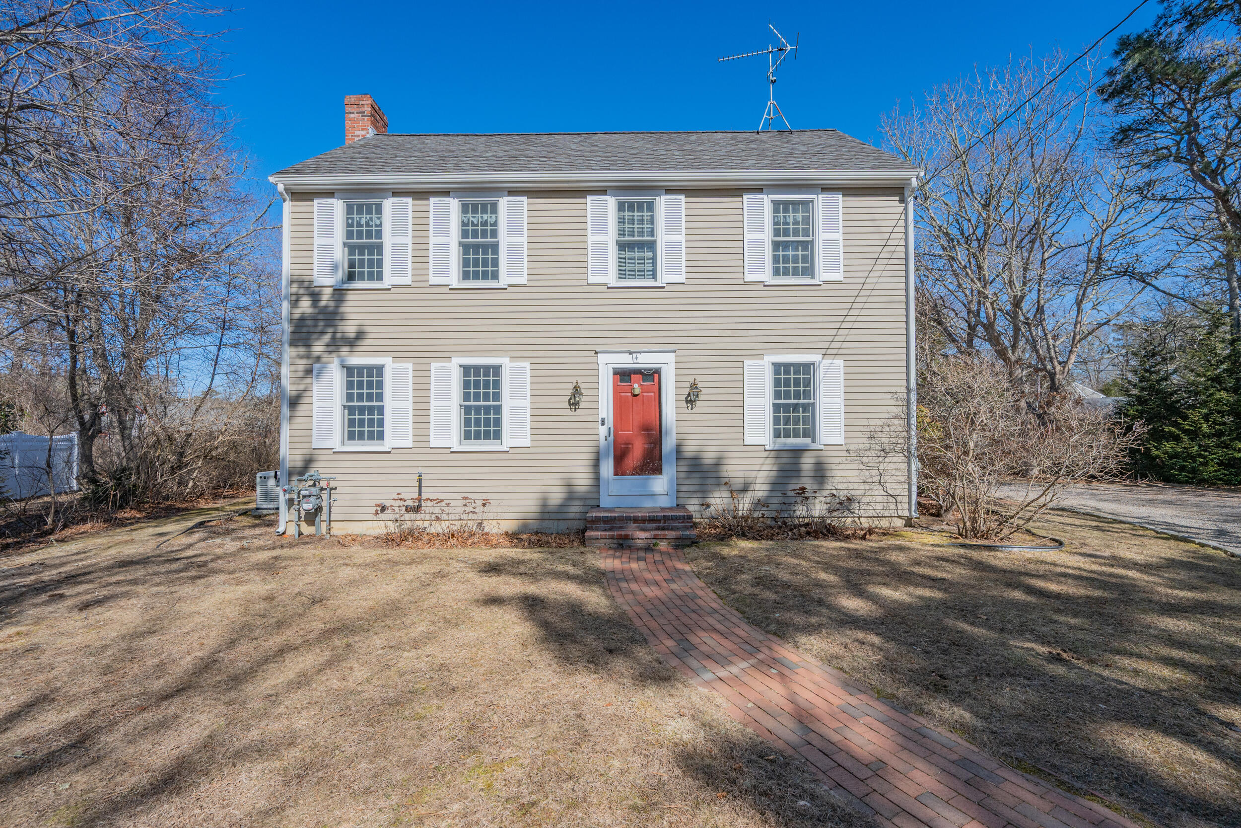 4 Ralyn Road Cotuit, MA 02635 - Photo 3 of 53 a front view of a house with a yard