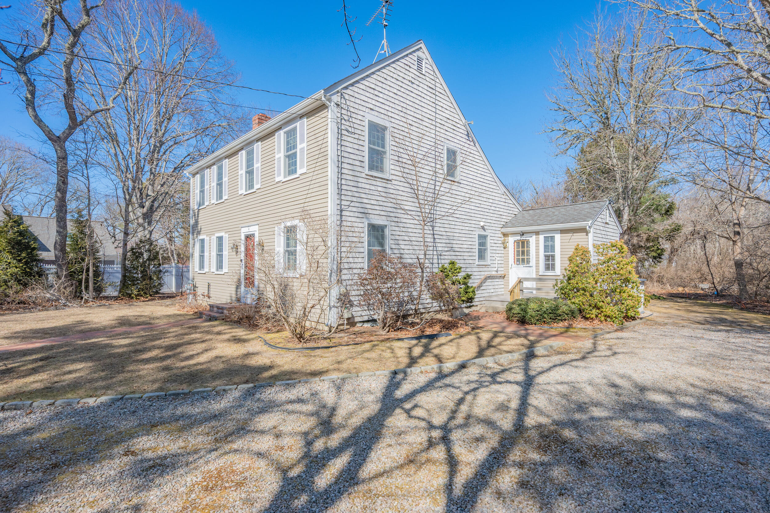 4 Ralyn Road Cotuit, MA 02635 - Photo 32 of 53 a front view of a house with a yard