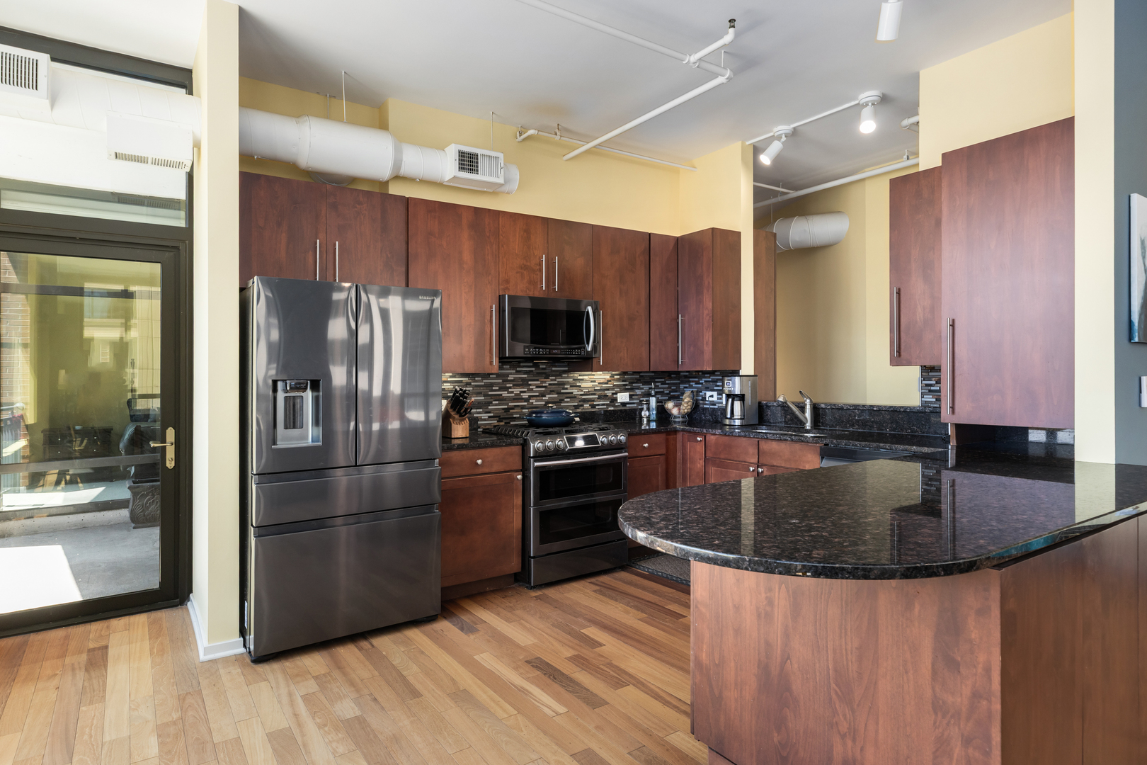 520 South State Street, Unit 1201 Chicago, IL 60605 - Photo 11 of 46 a kitchen with stainless steel appliances granite countertop a refrigerator a stove and a sink