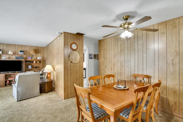 a view of a dining room with furniture and a chandelier