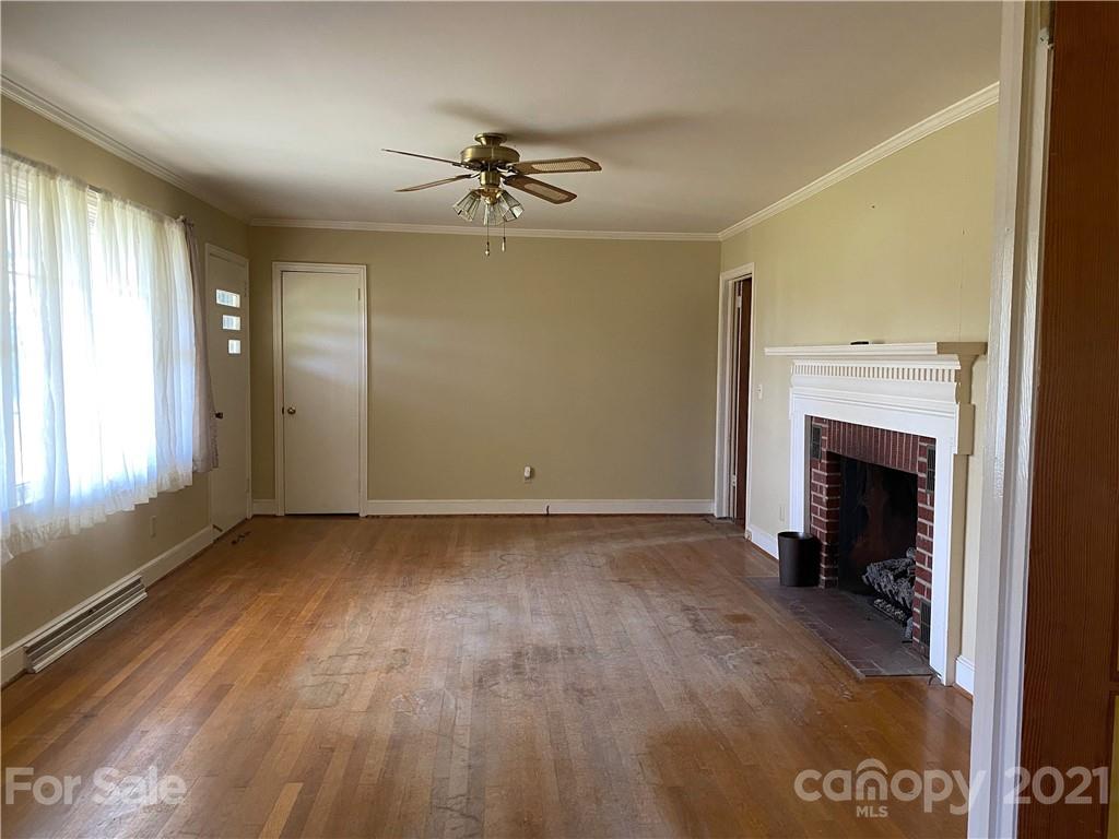 1565 Springlake Road York, SC 29745 - Photo 13 of 18 a view of an empty room with a fireplace and a window