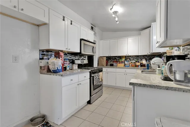 a kitchen with cabinets and appliances
