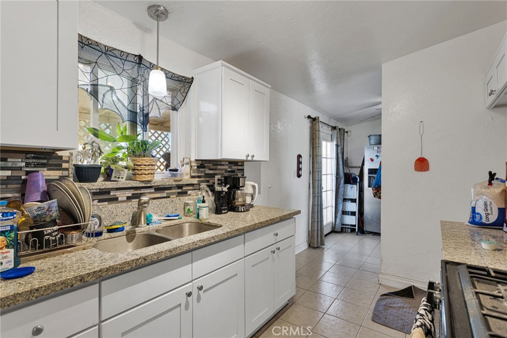 25488 Jade Road Barstow, CA 92311 - Photo 13 of 25 a kitchen with sink cabinets and window
