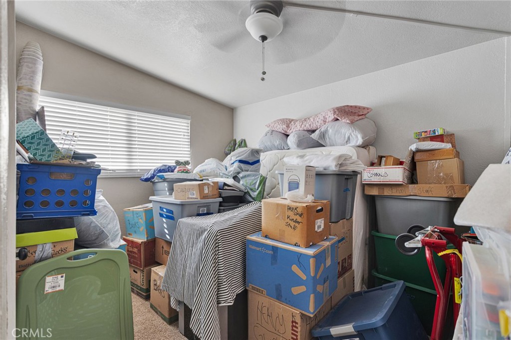 25488 Jade Road Barstow, CA 92311 - Photo 14 of 25 a bed room with furniture and a window