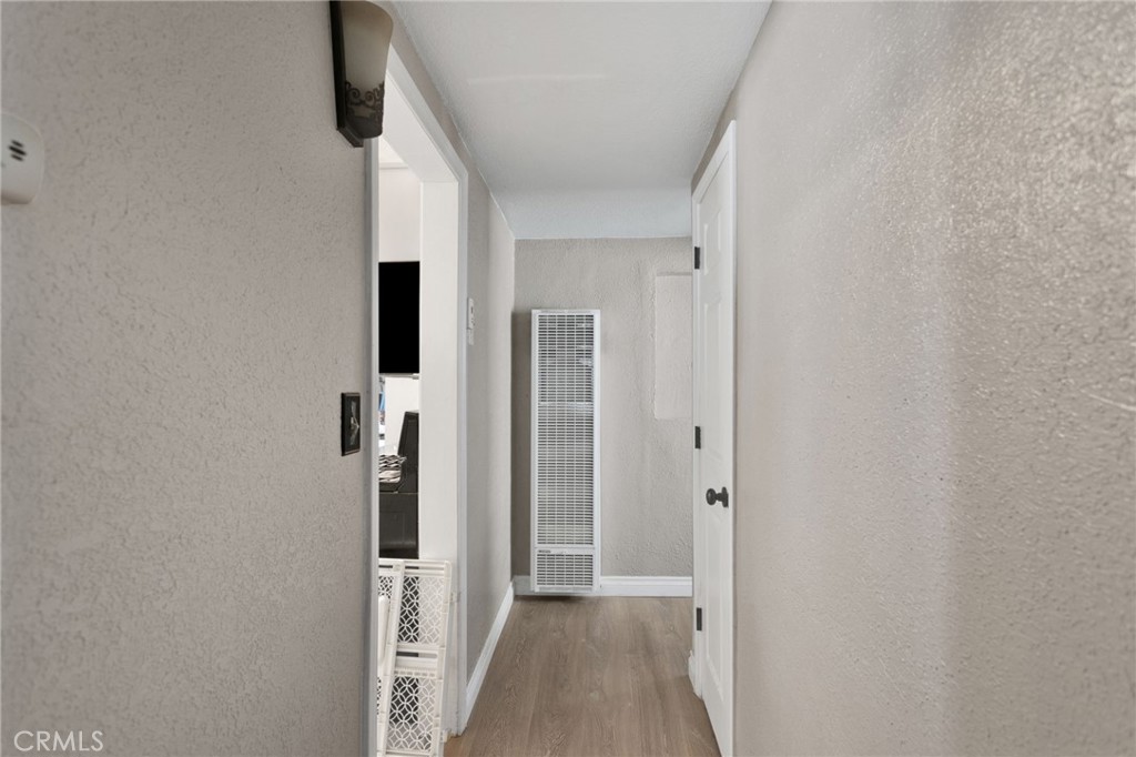 25488 Jade Road Barstow, CA 92311 - Photo 15 of 25 a view of a hallway with wooden floor and staircase