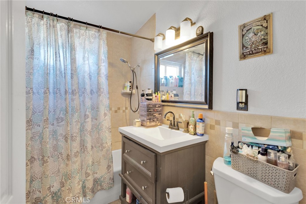 25488 Jade Road Barstow, CA 92311 - Photo 16 of 25 a bathroom with a sink vanity and a mirror