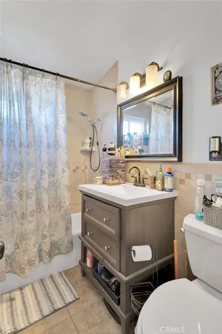 a bathroom with a double vanity sink mirror and toilet