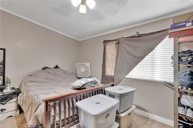 a bedroom with a bed and chandelier