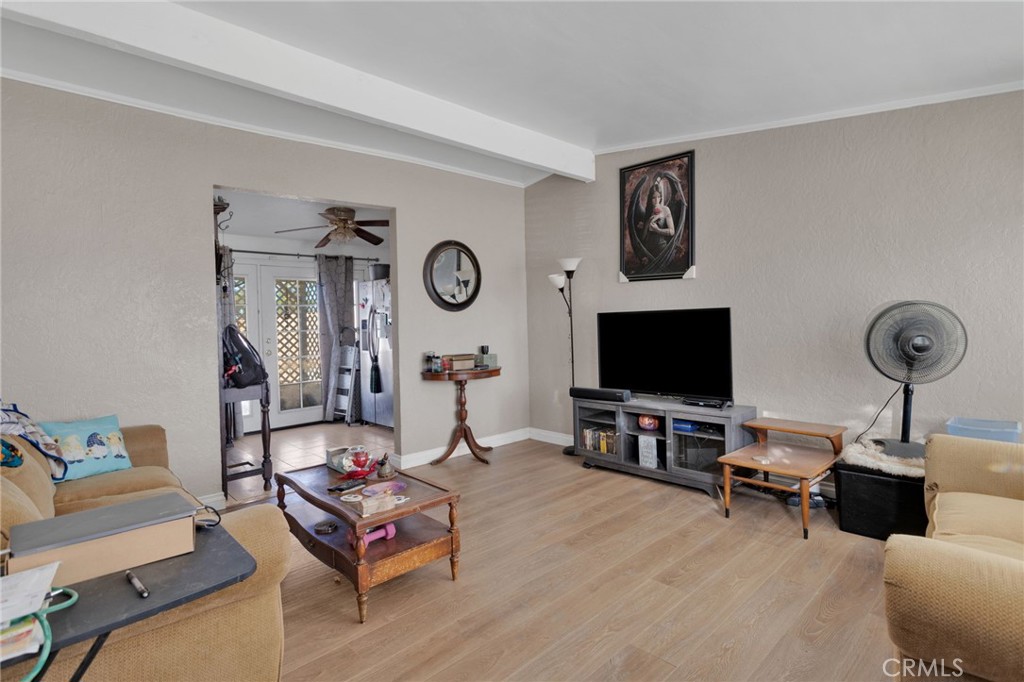 25488 Jade Road Barstow, CA 92311 - Photo 8 of 25 a living room with furniture and a flat screen tv