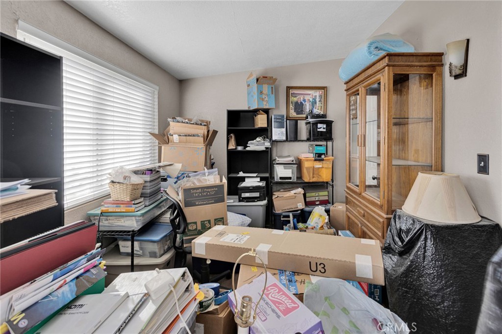 25488 Jade Road Barstow, CA 92311 - Photo 9 of 25 a reading room with furniture a flat screen tv and a window