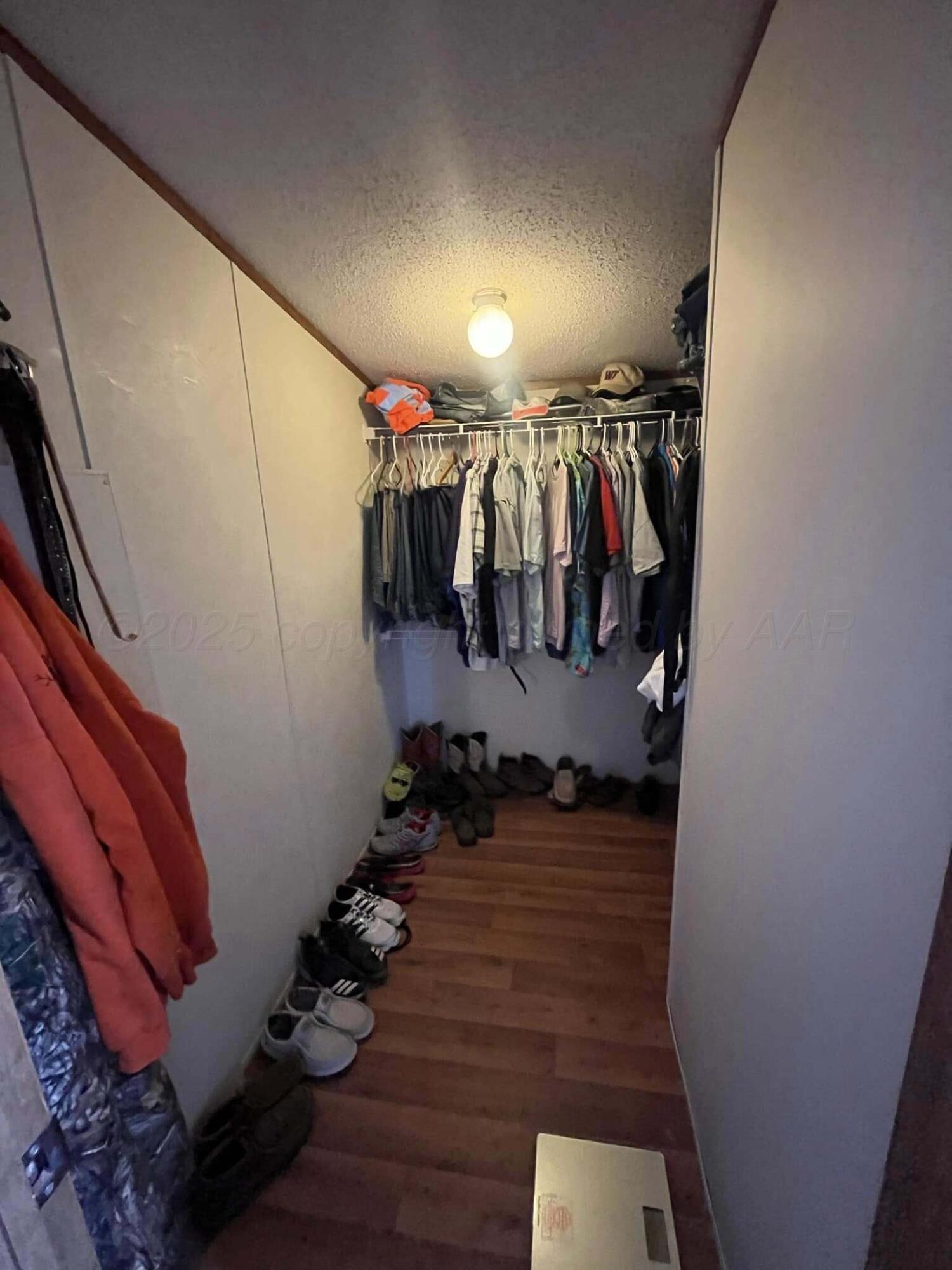 7101 Coyote Trail Amarillo, TX 79124 - Photo 11 of 14 a view of walk in closet with clothes and shoes