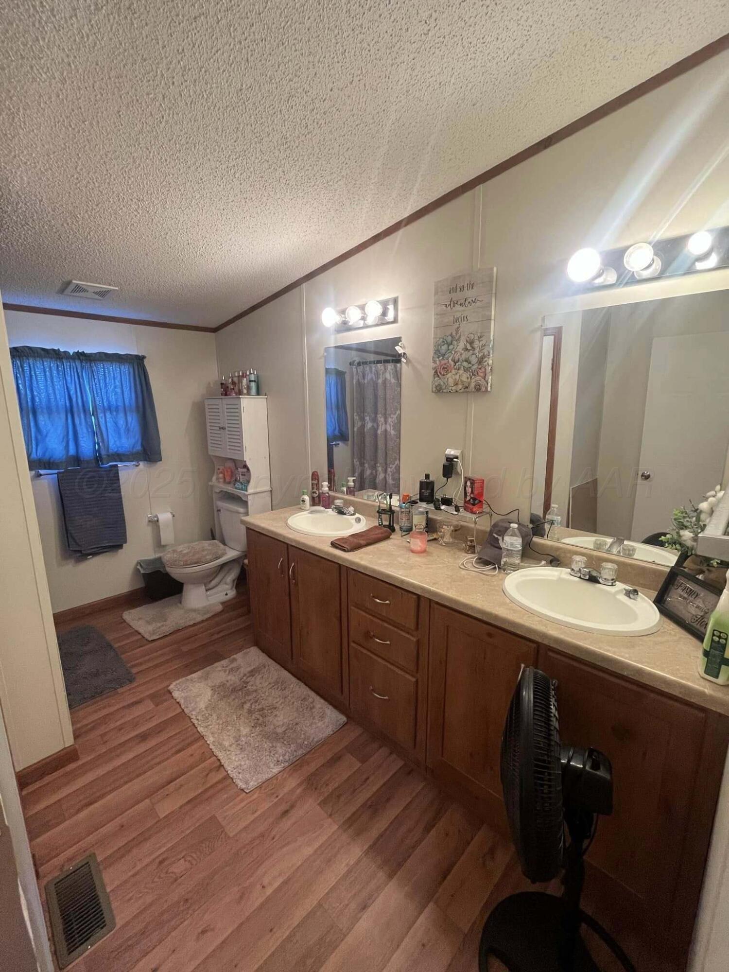 7101 Coyote Trail Amarillo, TX 79124 - Photo 13 of 14 a spacious bathroom with a double vanity sink and a mirror