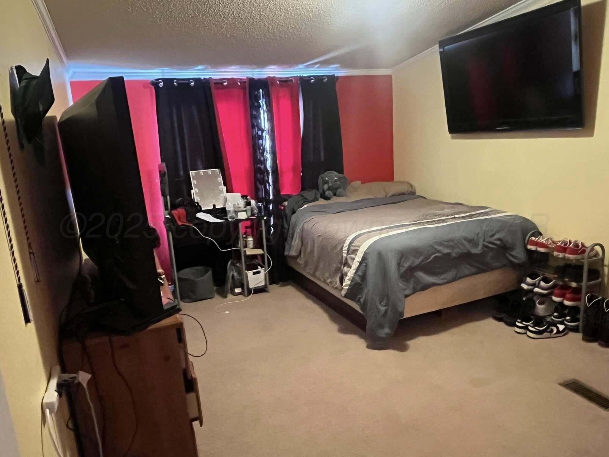 7101 Coyote Trail Amarillo, TX 79124 - Photo 14 of 14 a bed room with a bed a television and a fireplace