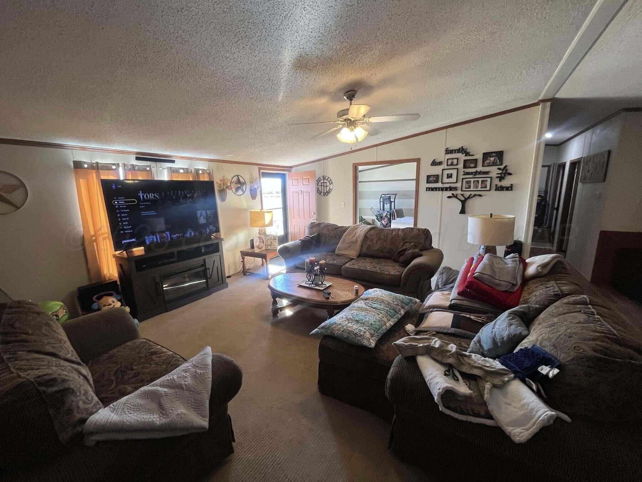 7101 Coyote Trail Amarillo, TX 79124 - Photo 3 of 14 a living room with furniture and a flat screen tv