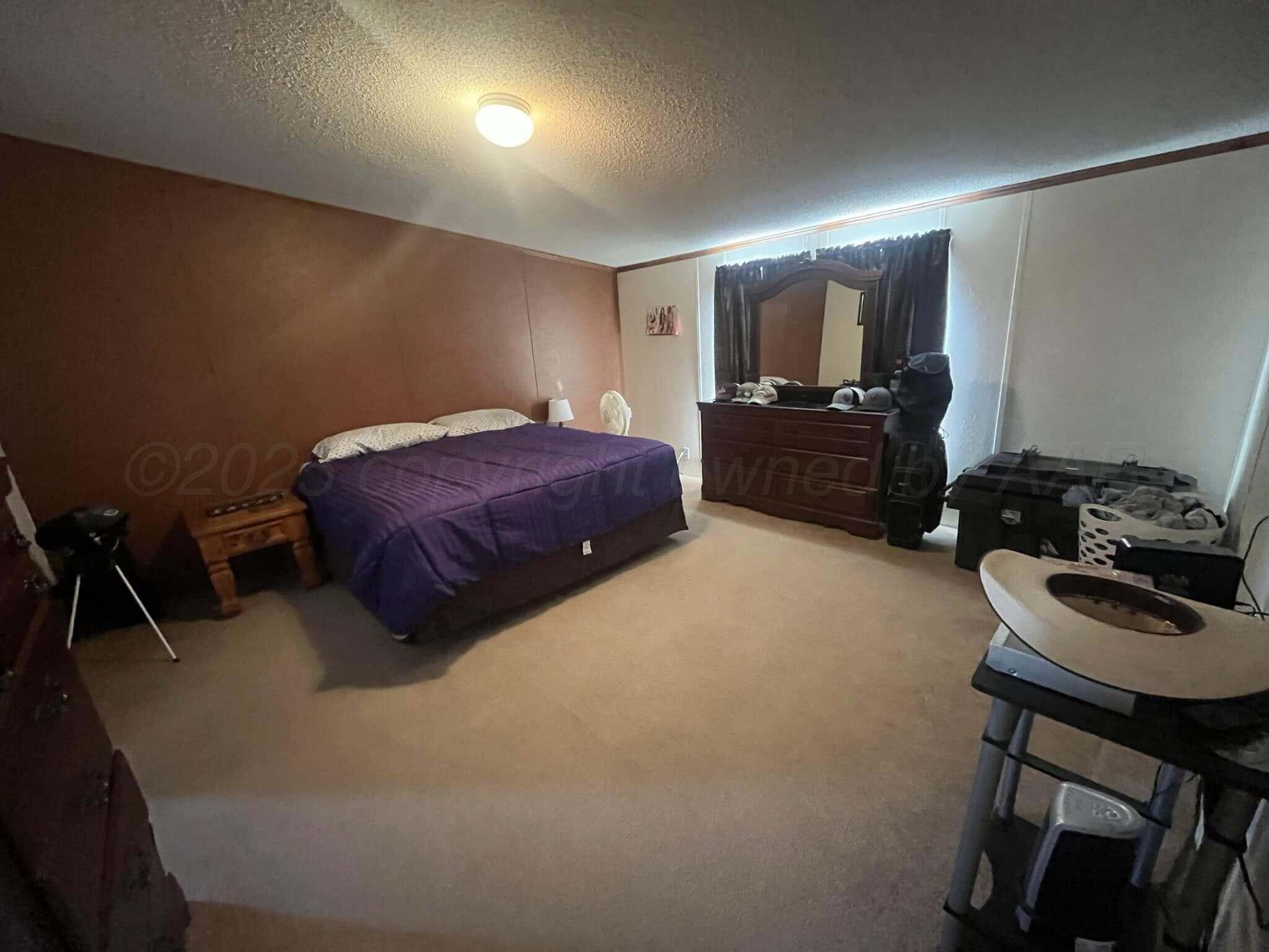 7101 Coyote Trail Amarillo, TX 79124 - Photo 7 of 14 a bedroom with a bed and a chair