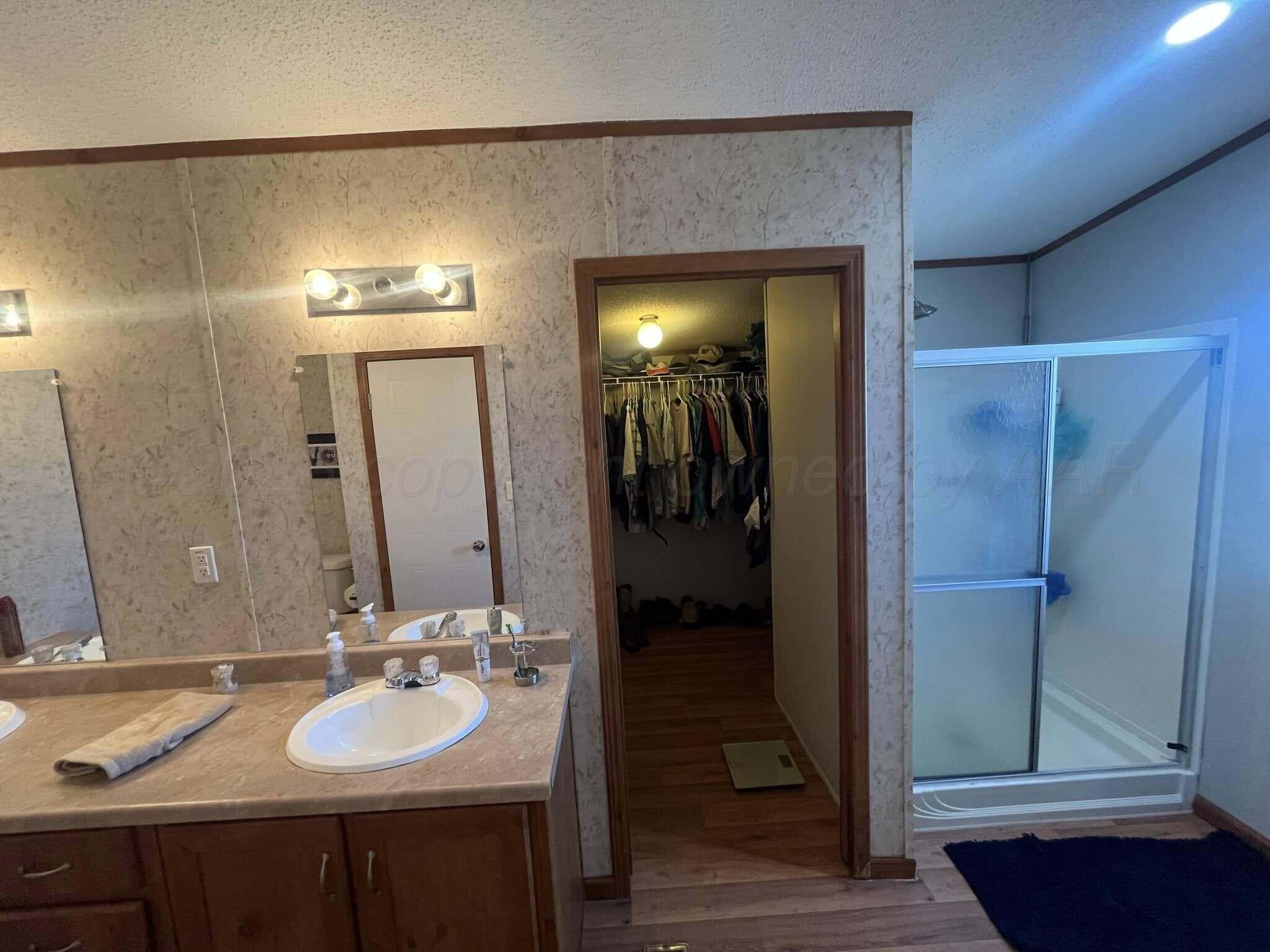7101 Coyote Trail Amarillo, TX 79124 - Photo 9 of 14 a bathroom with a sink and a mirror