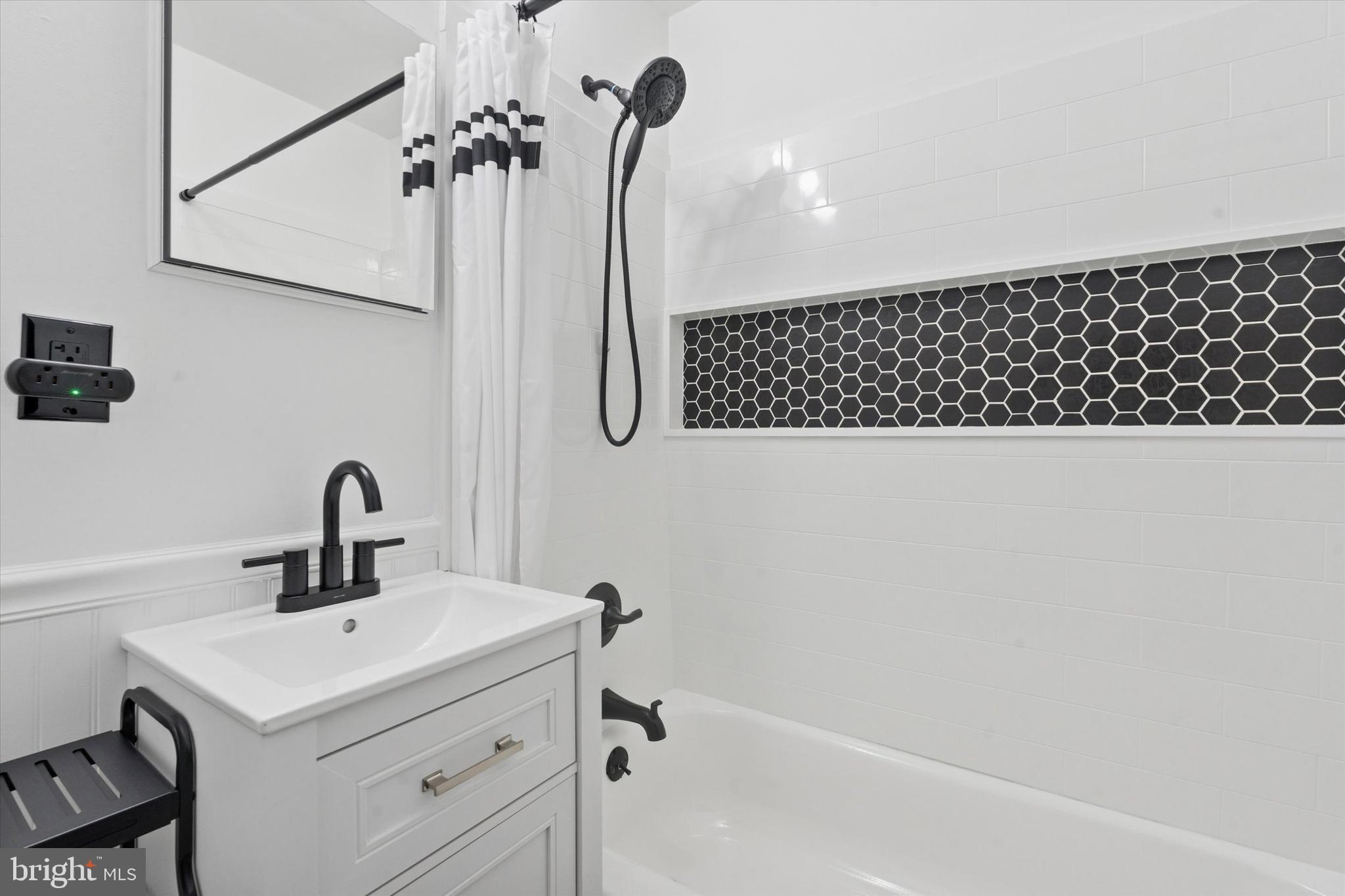 703 Hoffnagle Street, Unit 2 Philadelphia, PA 19111 - Photo 15 of 15 a bathroom with a sink a mirror and shower