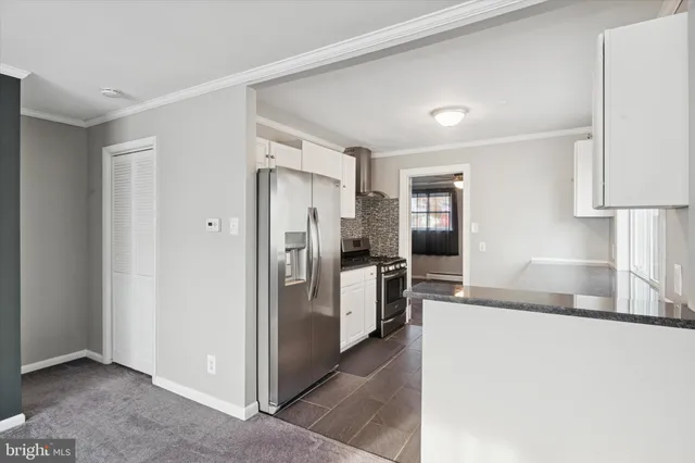 a kitchen with a refrigerator and a sink
