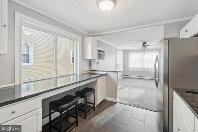 a kitchen with a refrigerator a sink and cabinets
