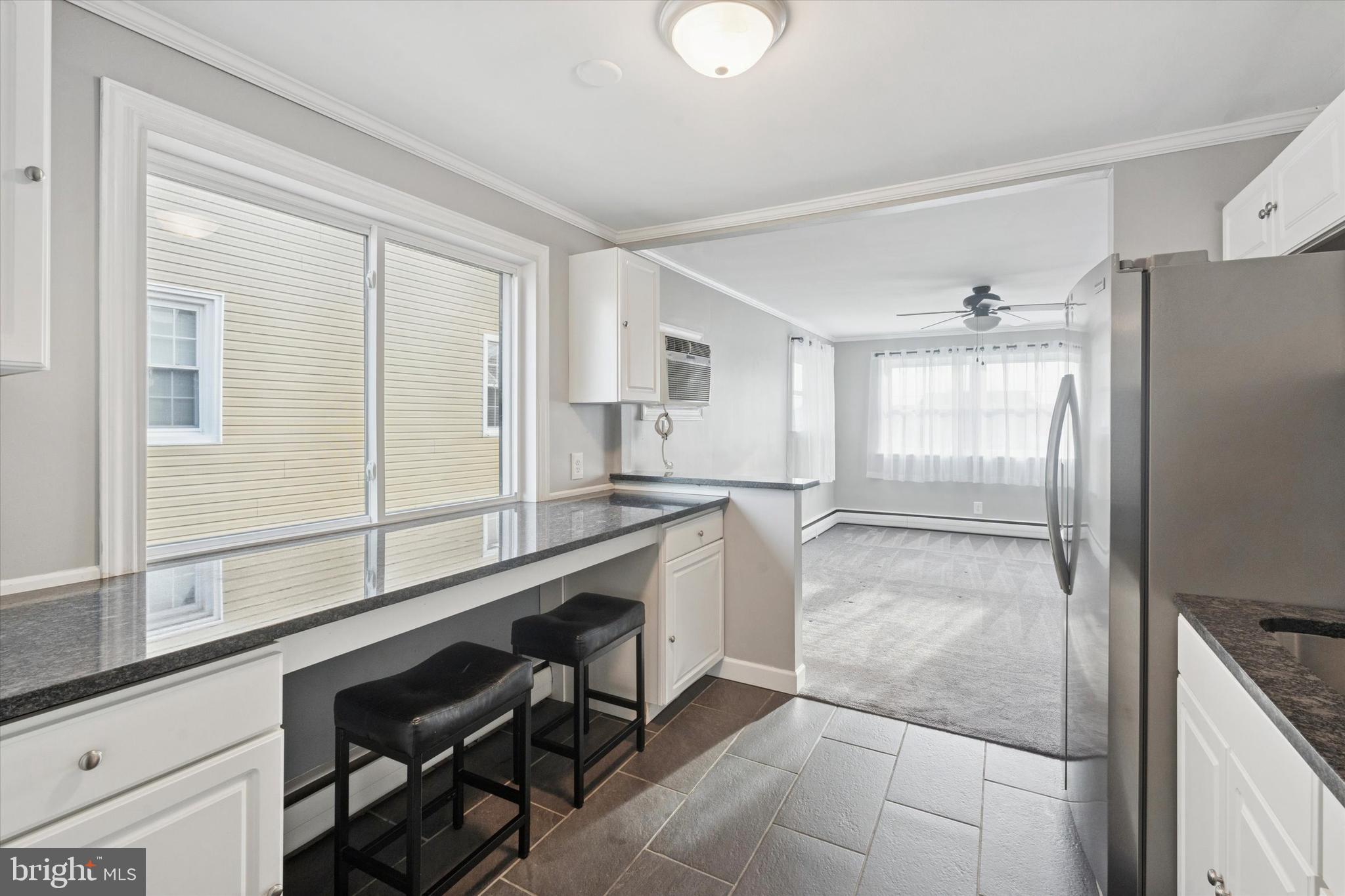 703 Hoffnagle Street, Unit 2 Philadelphia, PA 19111 - Photo 10 of 15 a kitchen with a refrigerator a sink and cabinets