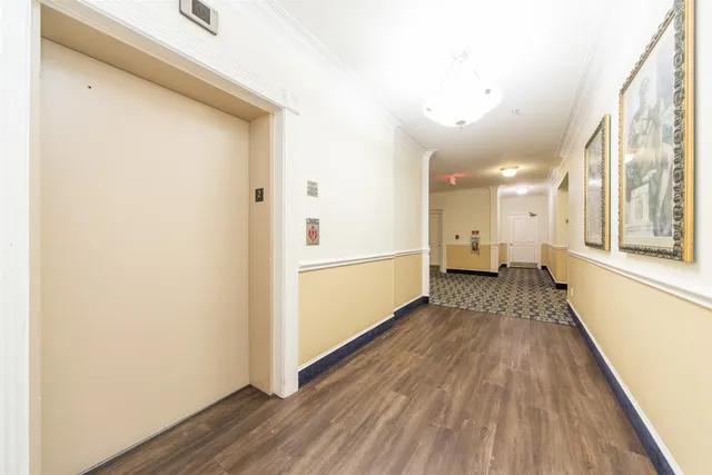 a view of a hallway with wooden floor