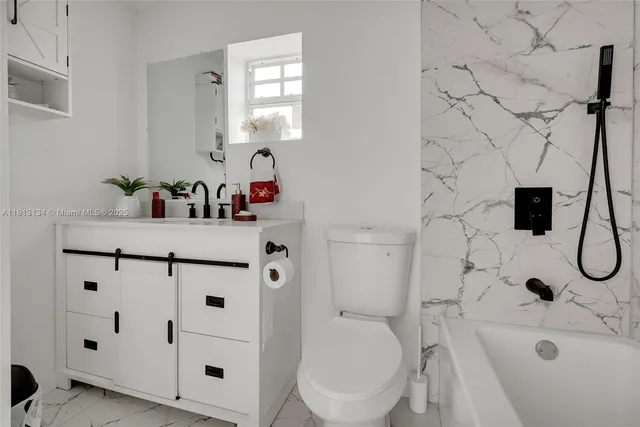 a bathroom with a sink toilet and shower