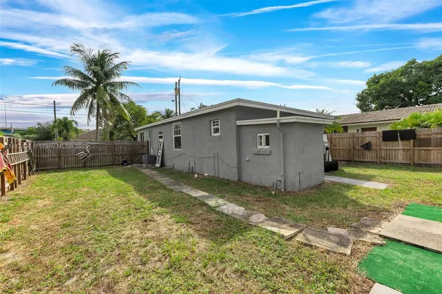 a view of a backyard of the house